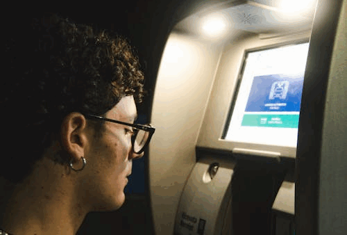 Person using an ATM machine.