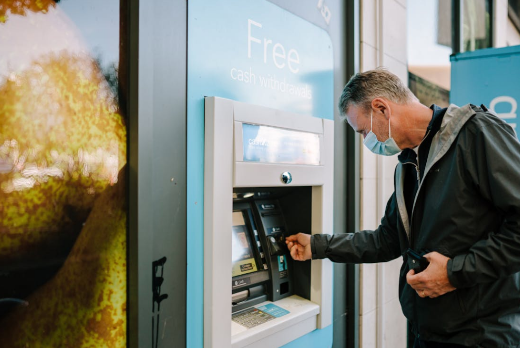 Man using a hybrid ATM and payment system