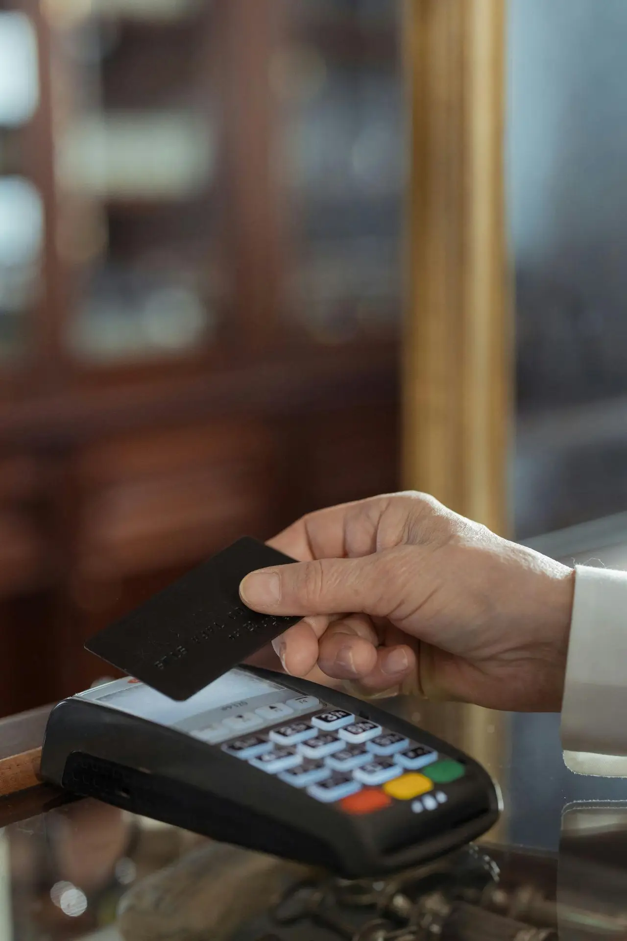 Customer using a debit card on a cashless ATM terminal at a dispensary checkout