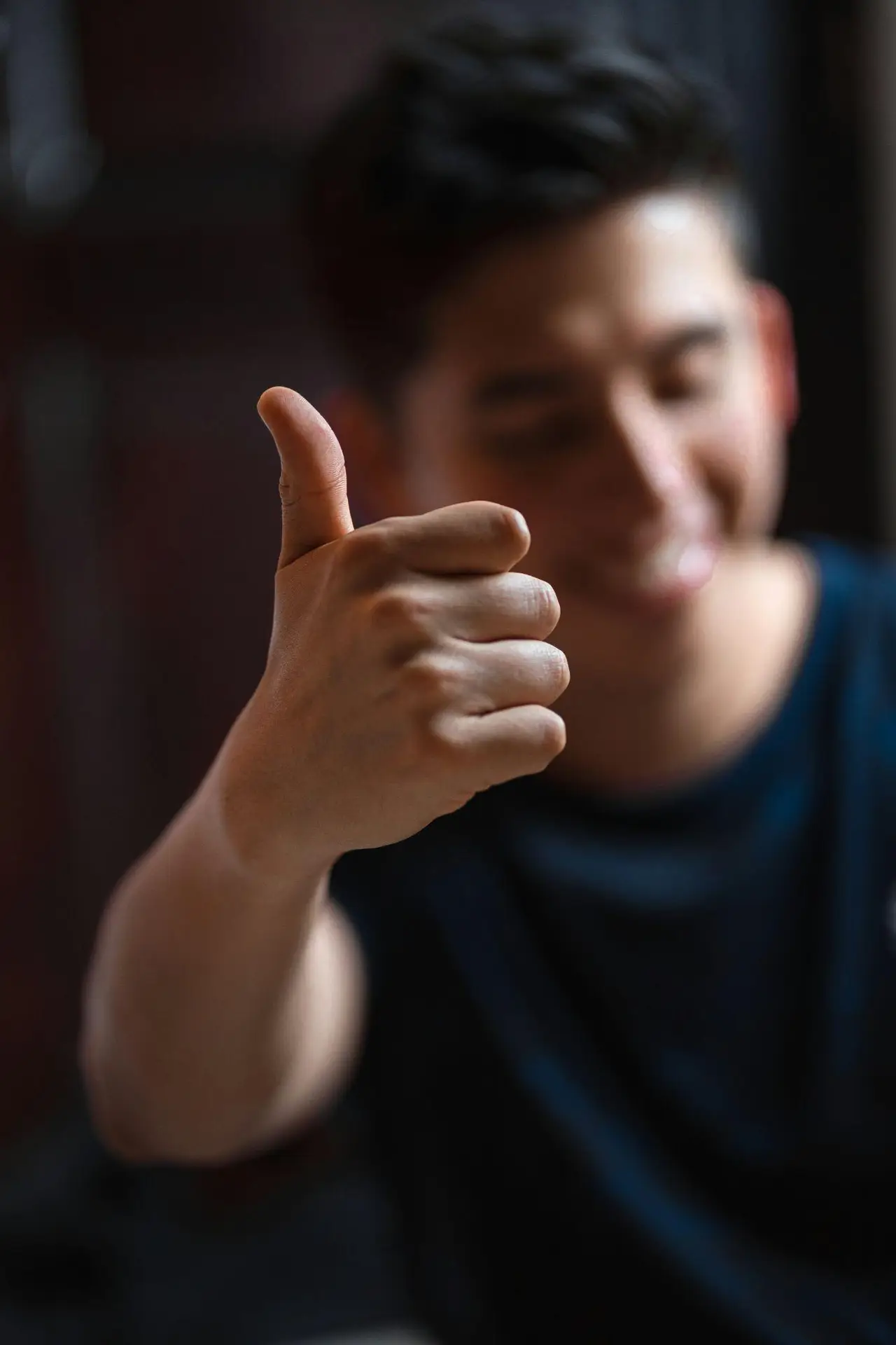 Smiling cannabis dispensary customer giving a thumbs up after a smooth checkout