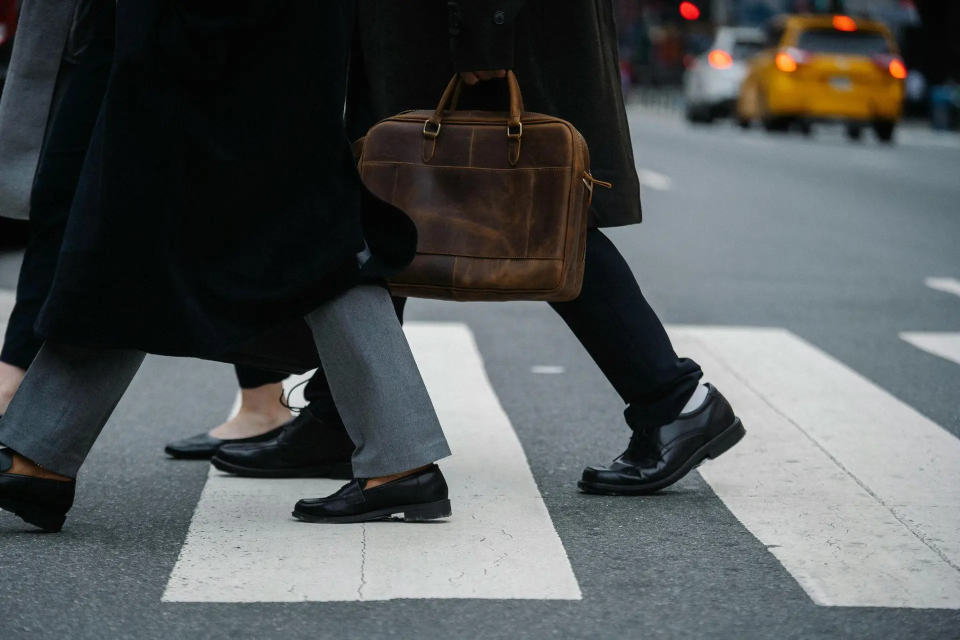People walking across a busy crosswalk representing increased foot traffic in retail environments